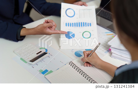 Business Strategy. Team analyzing budget data and financial graphs during a meeting. Business Strategy. Team analyzing budget data and financial graphs during a meeting. 131241384