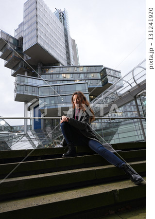 Fashion woman sitting on city stairs 131241920