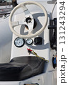 Steering wheel and dashboard of a motorboat showing navigation instruments 131243294