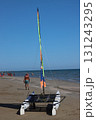 Sailor preparing catamaran on sandy beach for sailing in sunny day 131243295