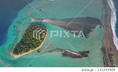 Aerial view of Tikehau tropical island in French Polynesia, turquoise water, lush vegetation palm trees, white beach, coral reef lagoon ocean barrier. Remote wild nature paradise, exotic summer travel Aerial view of Tikehau tropical island in French Polynesia, turquoise water, lush vegetation palm trees, white beach, coral reef lagoon ocean barrier. Remote wild nature paradise, exotic summer travel 131243909