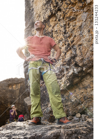 Climber standing confidently looking towards the mountain summit Climber standing confidently looking towards the mountain summit 131244233