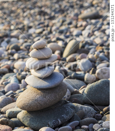 Cairn made of pebbles on the sea shore 131244371