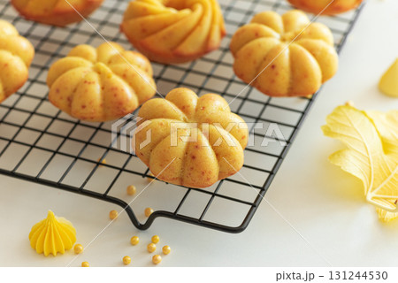 Autumn-Themed Mini pumpkin Cakes with Seasonal Decorations on White Background Autumn-Themed Mini pumpkin Cakes with Seasonal Decorations on White Background 131244530