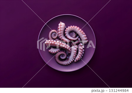 Octopus tentacles arranged on a purple plate against a matching purple background, seafood culinary concept 131244984
