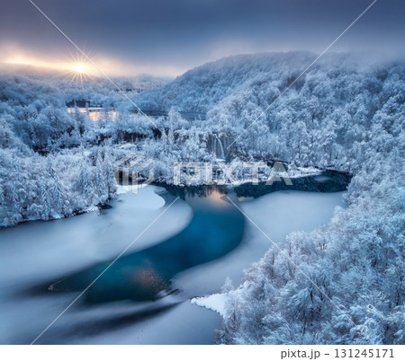 Aerial view of frozen lakes, waterfalls and snowy forest. Winter Aerial view of frozen lakes, waterfalls and snowy forest. Winter 131245171