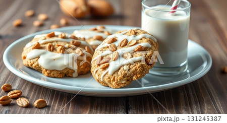 Delicious homemade cookies on a plate served with a glass of milk and peanuts on a wooden table Delicious homemade cookies on a plate served with a glass of milk and peanuts on a wooden table 131245387