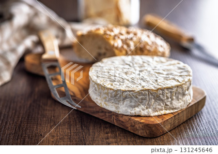 Camembert cheese on wooden table. French cheese with mold on the surface. 131245646