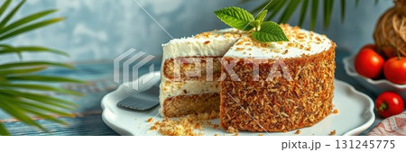 Delicious layered cake with creamy frosting and nuts served on a decorative plate with fresh herbs 131245775