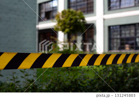 Close up of caution tape symbolizing emergency or accident scene. The yellow and black stripes highlight the restricted area and emphasize urgency, making it perfect for safety or rescue contexts 131245803
