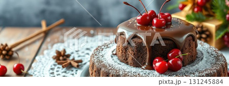 Delicious chocolate cake topped with cherries and surrounded by festive decorations during a winter celebration 131245884
