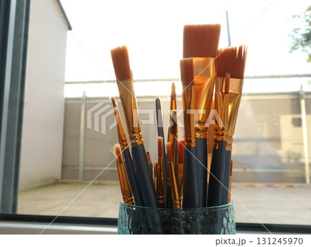Paint Brushes in Glass Jar by Sunlit Window - Artist Studio Tools and Supplies Paint Brushes in Glass Jar by Sunlit Window - Artist Studio Tools and Supplies 131245970