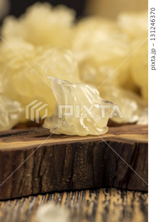 yellow juicy citrus fruit peeled, pieces of delicious and sweet citrus fruit while preparing it for eating, closeup yellow juicy citrus fruit peeled, pieces of delicious and sweet citrus fruit while preparing it for eating, closeup 131246370
