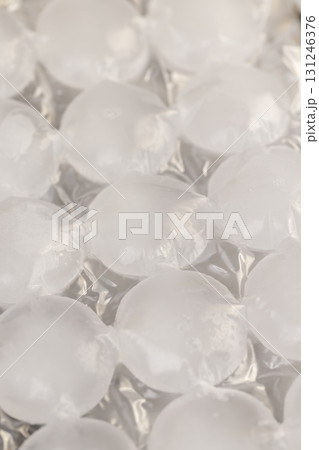 white ice in bags for freezing water, frozen water in special bags for making ice and using it in drinks and cocktails white ice in bags for freezing water, frozen water in special bags for making ice and using it in drinks and cocktails 131246376