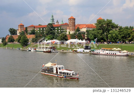 Tourist boats cruise the Vistula River in Krakow, Poland, Tourist boats cruise the Vistula River in Krakow, Poland, 131246529