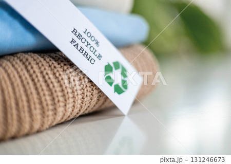 Recycled Fabric Tag on Sustainable Clothing Stack for Eco Friendly Textile Concept Recycled Fabric Tag on Sustainable Clothing Stack for Eco Friendly Textile Concept 131246673