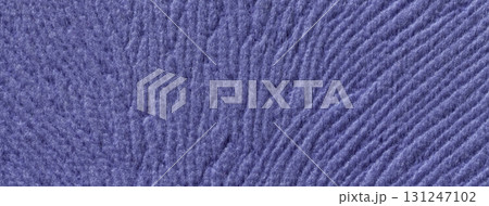 Dark violet background from soft fluffy textile material macro. Texture of purple plush fabric backdrop. Wavy pattern 131247102