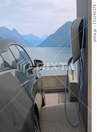 Electric car next to charging station Electric car next to charging station 131248379