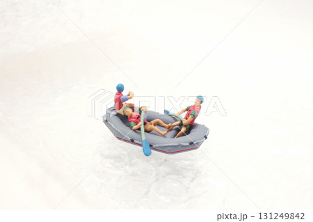 Miniature Figures In A Tiny Boat On Icy Snow Surface Miniature Figures In A Tiny Boat On Icy Snow Surface 131249842