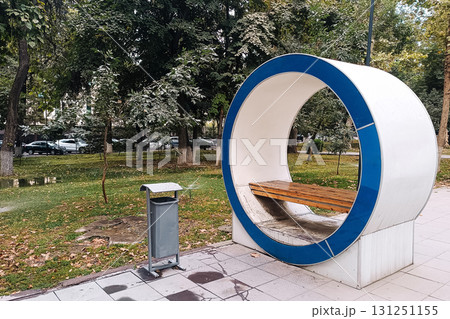 sculpture of a round bench in a city park on a sunny autumn day sculpture of a round bench in a city park on a sunny autumn day 131251155