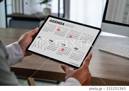 , red date markers, and monthly view in a modern office of meeting schedule, time management , red date markers, and monthly view in a modern office of meeting schedule, time management 131252363