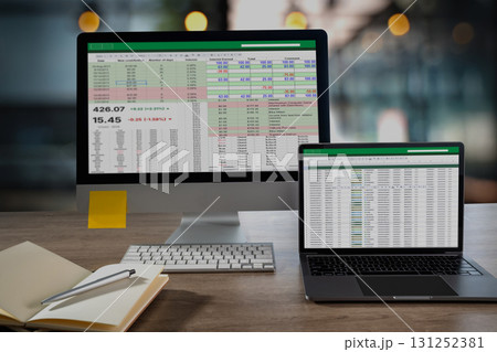laptop display a detailed spreadsheet with financial figures and color coded rows on a tidy office desk ideal visual for analytics KPI laptop display a detailed spreadsheet with financial figures and color coded rows on a tidy office desk ideal visual for analytics KPI 131252381