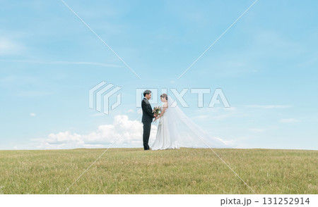 ベールをなびかせる空バックの新郎新婦(ウェディング・結婚式・ブライダル・フォトウェディング) ベールをなびかせる空バックの新郎新婦(ウェディング・結婚式・ブライダル・フォトウェディング) 131252914