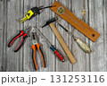 Assorted work tools lying on rustic wooden table Assorted work tools lying on rustic wooden table 131253116