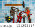 Plumbing tools lying on blue tiles getting ready for work Plumbing tools lying on blue tiles getting ready for work 131253117