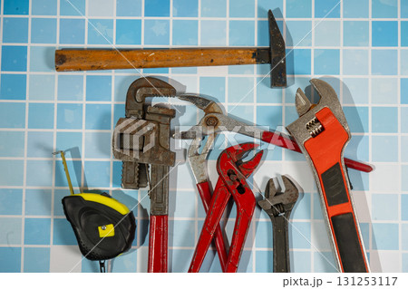 Plumbing tools lying on blue tiles getting ready for work 131253117