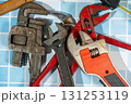 Plumbing tools laying on blue tiles ready for a plumber to use Plumbing tools laying on blue tiles ready for a plumber to use 131253119