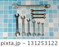 Set of wrenches lying on blue tiles, showing plumbing and maintenance concept Set of wrenches lying on blue tiles, showing plumbing and maintenance concept 131253122