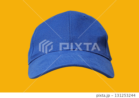 Blue cap modeled on bright yellow backdrop for design showcase Blue cap modeled on bright yellow backdrop for design showcase 131253244