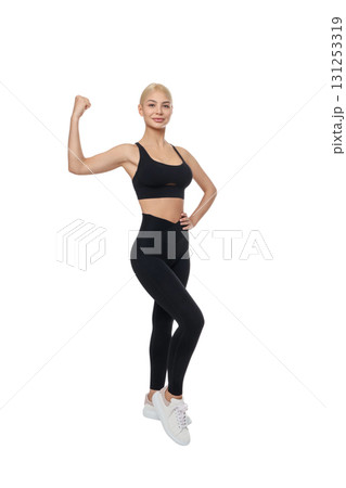 Woman shows strength and confidence in yoga attire, isolated, PNG 131253319