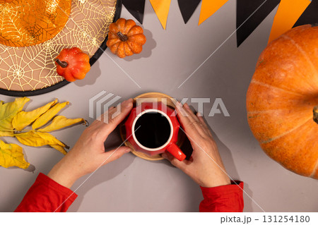 Enjoying Coffee During Halloween Thanksgiving Season 131254180