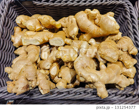 Fresh Organic Ginger Roots in a Woven Basket for Culinary Use Fresh Organic Ginger Roots in a Woven Basket for Culinary Use 131254377