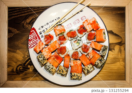 Japanese food restaurant delivery - sushi maki california roll platter set isolated at wooden background, above view Japanese food restaurant delivery - sushi maki california roll platter set isolated at wooden background, above view 131255294
