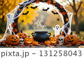 A frame consisting of a garland of Halloween elements: pumpkins, a black cauldron, skulls, cobwebs and spiders, bats, and cheerful ghosts 131258043