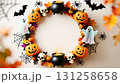 A frame consisting of a garland of Halloween elements: pumpkins, a black cauldron, skulls, cobwebs and spiders, bats, and cheerful ghosts 131258658