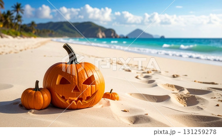 Halloween decorations on a sunny beach with carved pumpkins and waves in the background 131259278