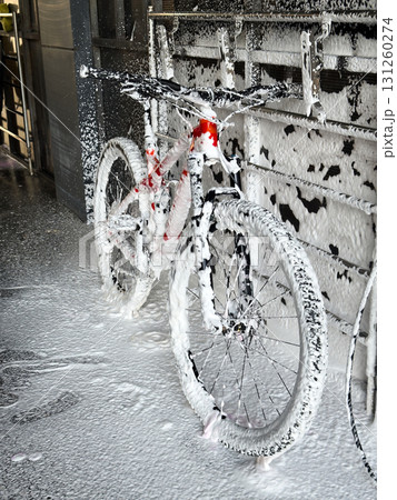Washing a bicycle with foam at a self-service car wash. Bike care 131260274