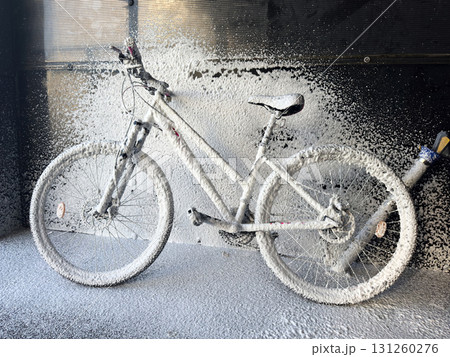 Washing a bicycle with foam at a self-service car wash. Bike care 131260276