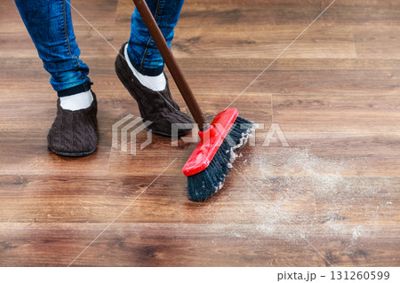 Cleaning woman sweeping wooden floor 131260599