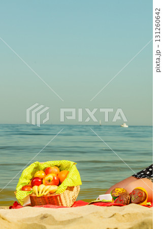 Picnic basket on blanket near sea Picnic basket on blanket near sea 131260642
