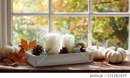 Elegant display of candles with colorful pumpkins and pinecones adds a cozy touch to the autumn season in a bright setting 131261824
