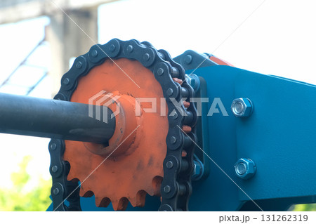 Orange metal gear mechanism rotating on industrial plant factory. Orange metal gear mechanism rotating on industrial plant factory. 131262319