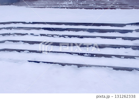 Steps in the snow at entrance to the building in winter, slippery stairs. Steps in the snow at entrance to the building in winter, slippery stairs. 131262338