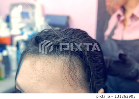 Application of keratin to the hair with a brush. Strengthening the hair with keratin. Application of keratin to the hair with a brush. Strengthening the hair with keratin. 131262905