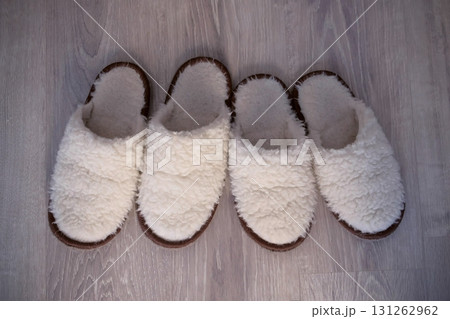 Two pairs of white slippers from sheep wool, closeup view. 131262962