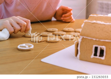 Woman's hands decorate christmas cookies with sugar sweet icing. Woman's hands decorate christmas cookies with sugar sweet icing. 131263033